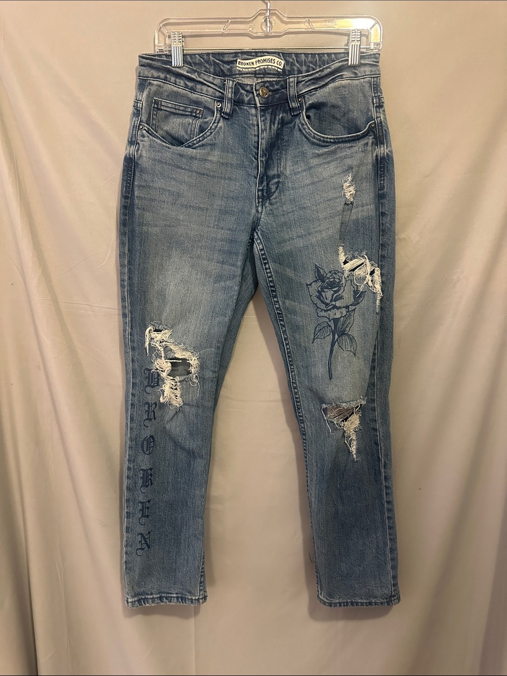 Broken Promises Women's Distressed Light Blue Rose Graphic Jeans